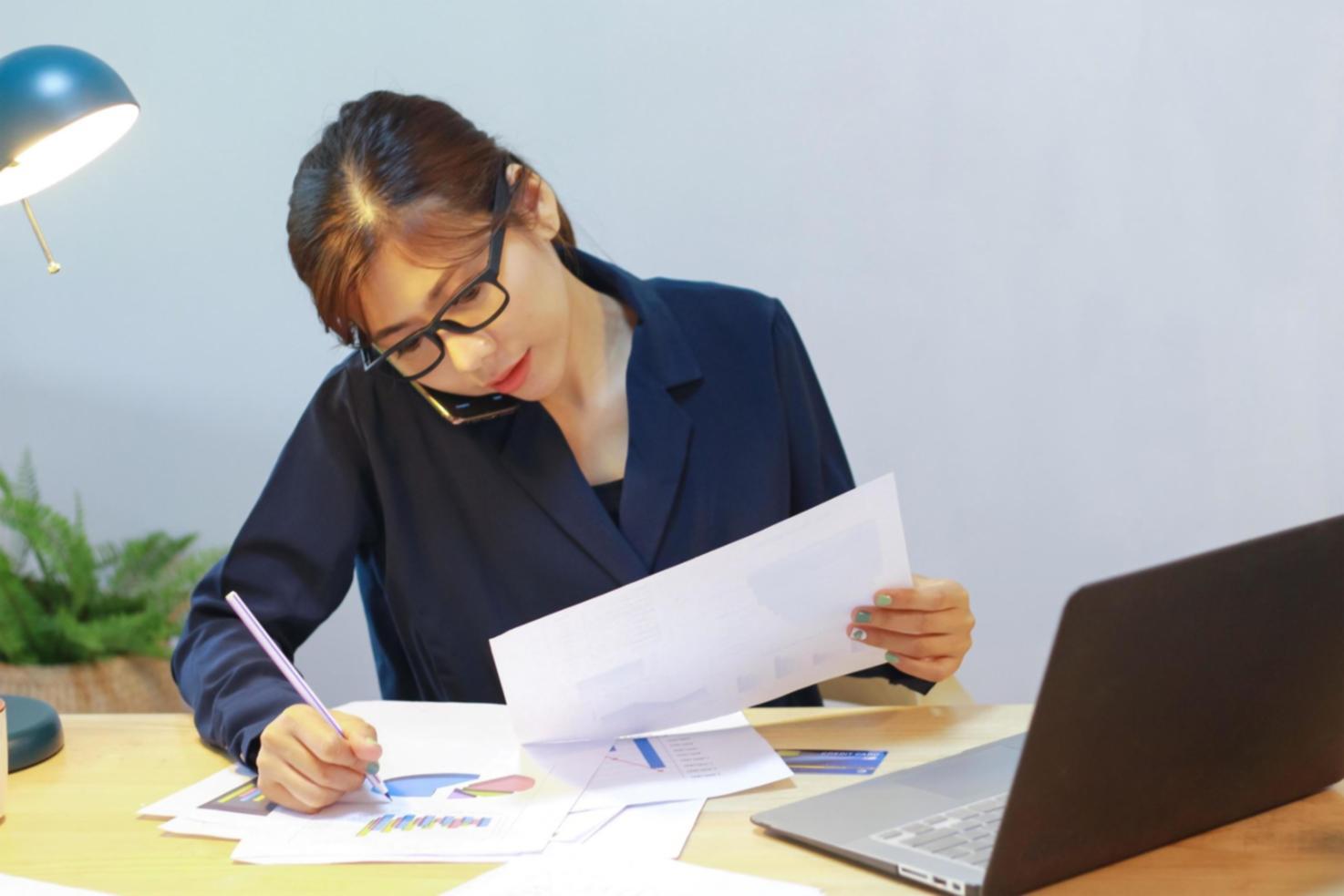 Financial analysis workspace with documents and calculator